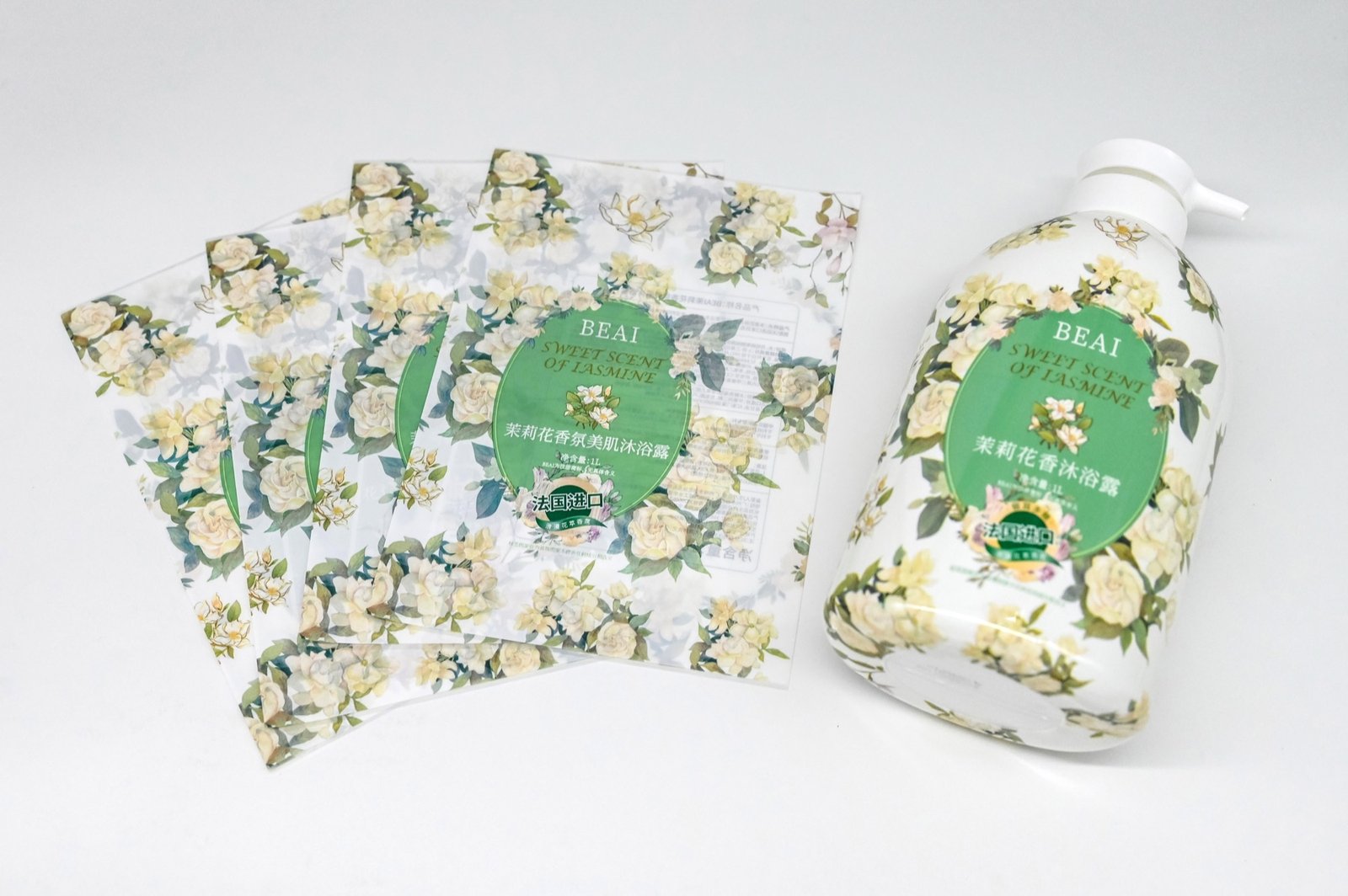 Real decorated personal care bottle alongside loose printed sleeve samples